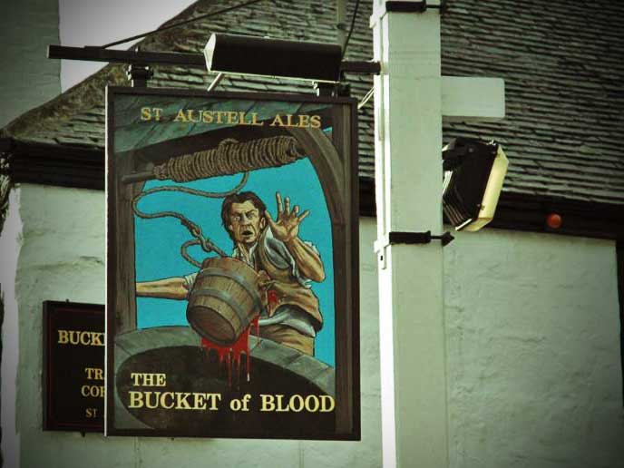 The sign for the Bucket of Blood shoign a startled landlord by a bucket film with blood..