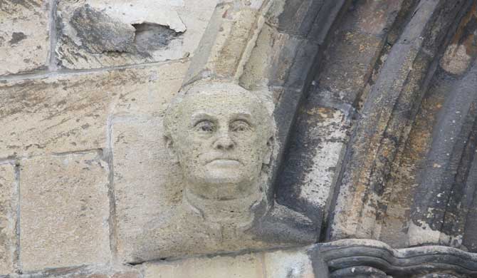 A carved face on a church wall.
