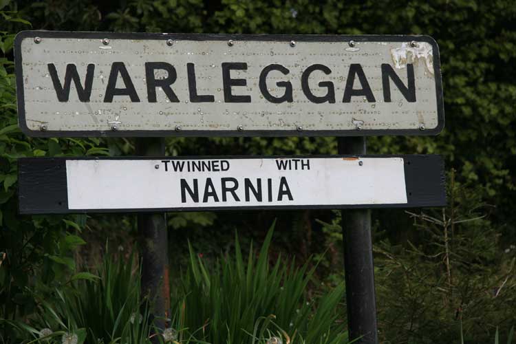 The Warleggan village sign beneath which is written twinned with Narnia.